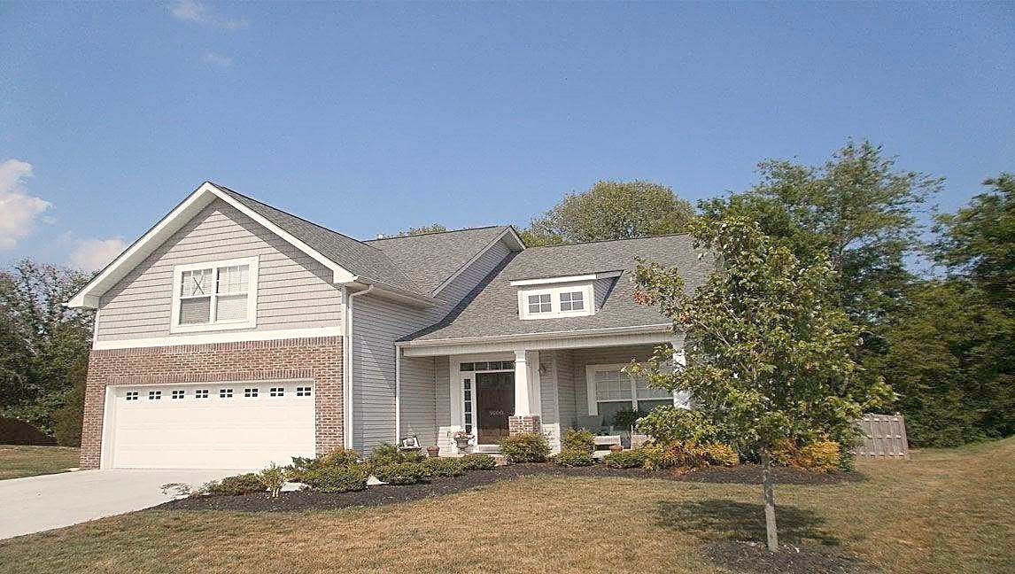 A two-story home with a new shingle roof, garage and front porch